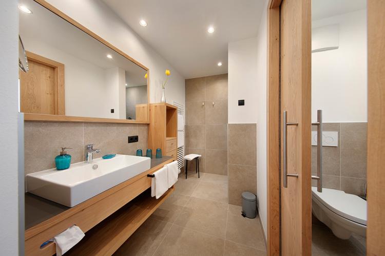 Bathroom with spacious shower with rainfall showerhead